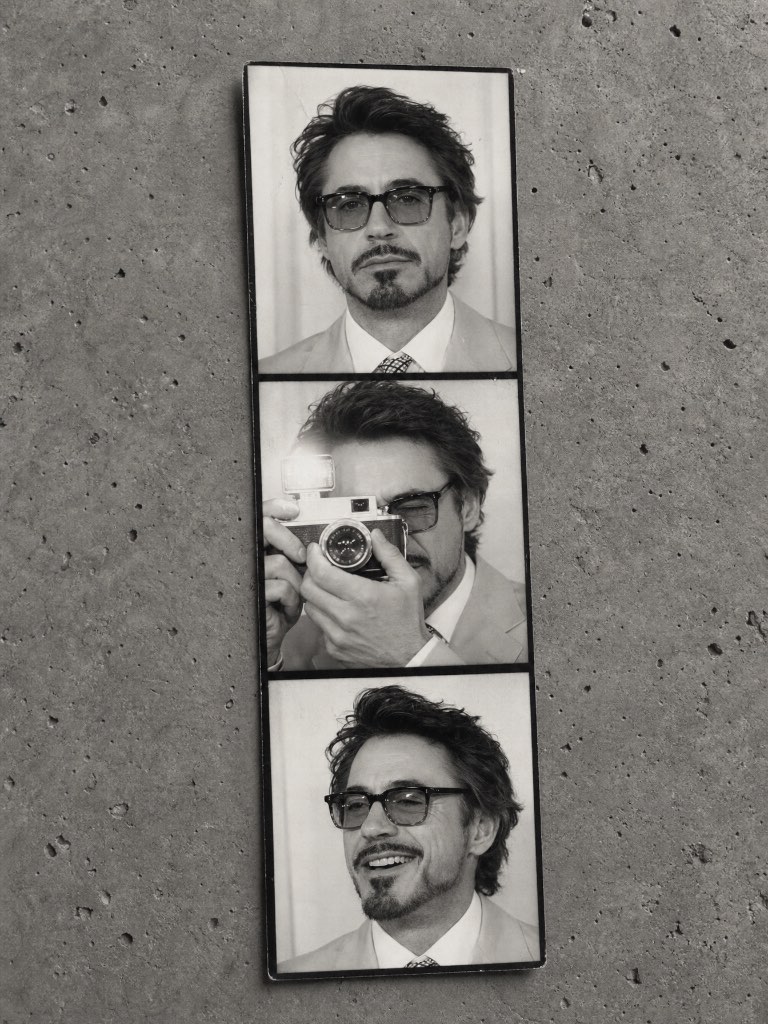 Three-frame black-and-white photo strip of a bearded man with glasses, including a camera portrait, on concrete.
